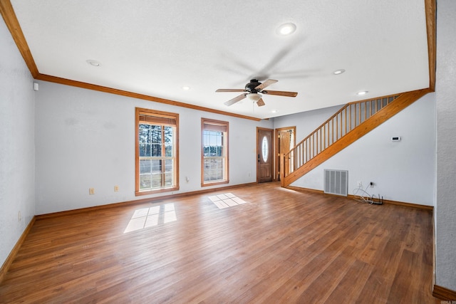 unfurnished living room featuring hardwood / wood-style flooring, ceiling fan, and ornamental molding