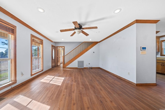 unfurnished living room featuring ceiling fan, wood-type flooring, and crown molding