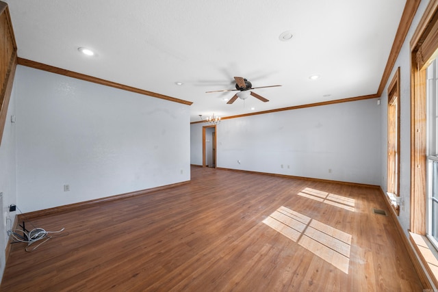 unfurnished room featuring hardwood / wood-style flooring, ceiling fan, crown molding, and a wealth of natural light