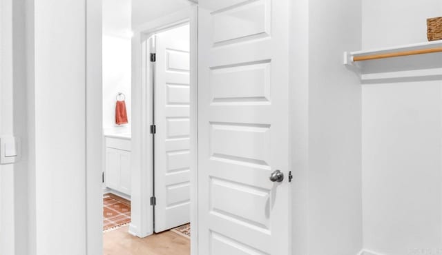 hallway with light hardwood / wood-style floors