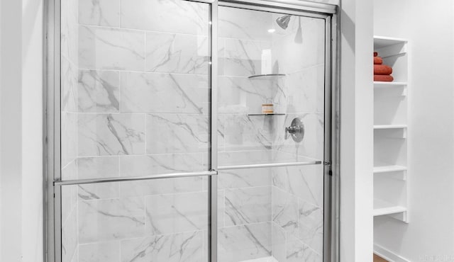 bathroom with a shower with shower door