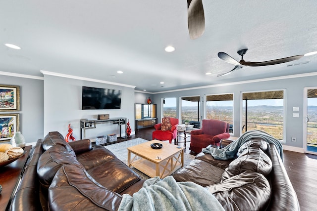 living room with dark hardwood / wood-style flooring, ceiling fan, and crown molding