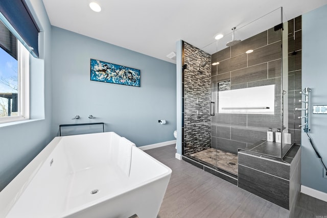 bathroom with shower with separate bathtub and toilet