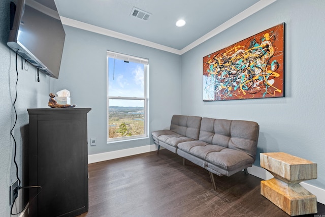 living area with dark wood-type flooring and ornamental molding