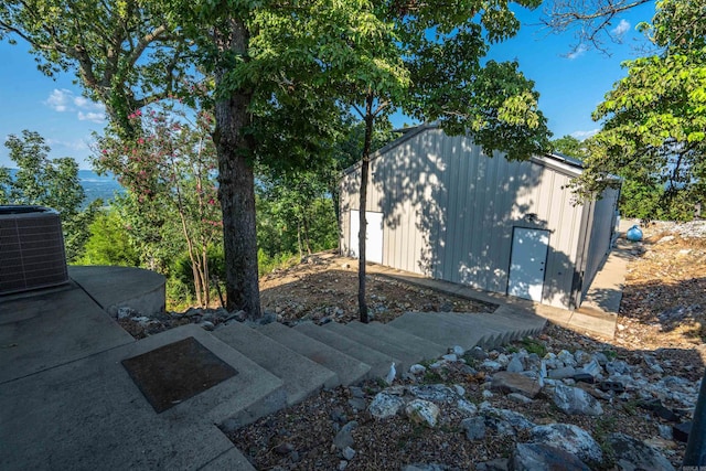 view of side of home featuring central AC