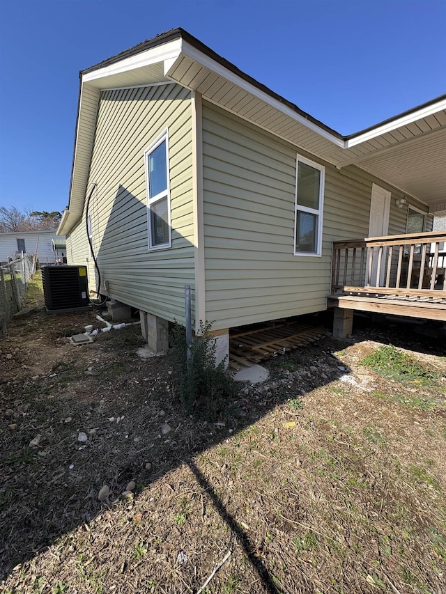 view of side of property with a deck and cooling unit