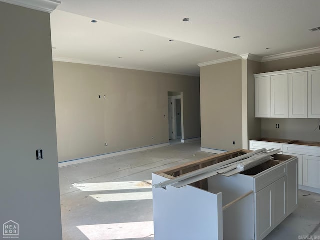 kitchen featuring white cabinets and ornamental molding