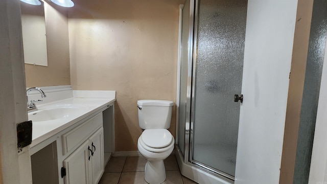 bathroom featuring tile patterned floors, vanity, toilet, and an enclosed shower