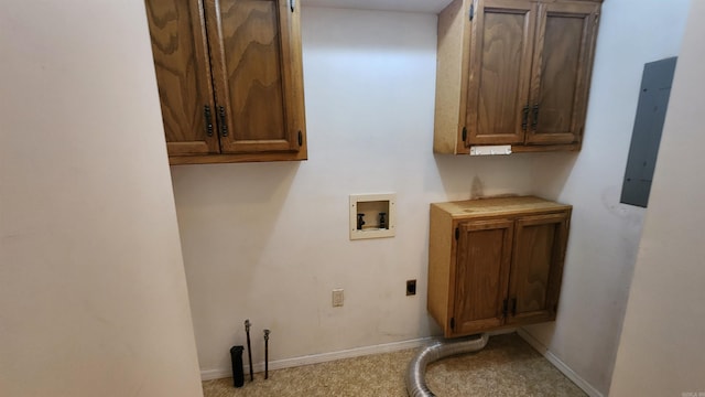 laundry area with hookup for an electric dryer, hookup for a washing machine, electric panel, and cabinets