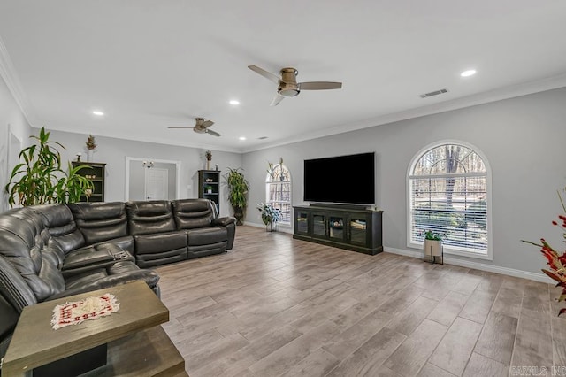 living room with ceiling fan, light hardwood / wood-style floors, and crown molding