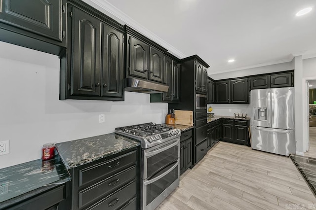 kitchen featuring stainless steel appliances, crown molding, and dark stone countertops