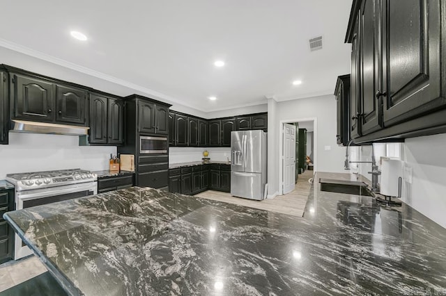 kitchen featuring dark stone countertops, crown molding, and appliances with stainless steel finishes