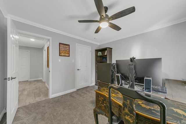 carpeted home office featuring ceiling fan and crown molding