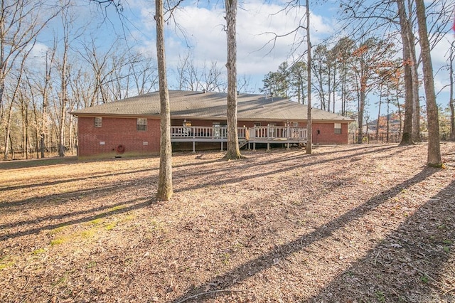 back of house with a deck