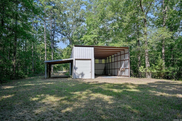 view of outdoor structure featuring a yard and a carport