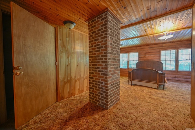 bedroom with log walls, carpet, a closet, and wooden walls