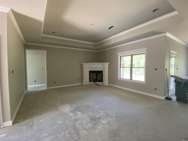 unfurnished living room with visible vents, a raised ceiling, a fireplace, crown molding, and baseboards