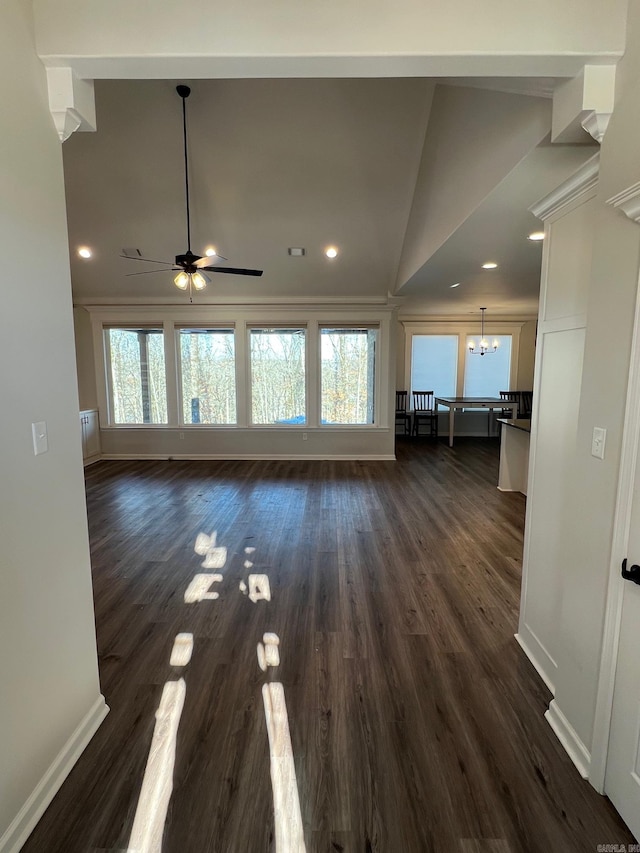 unfurnished living room featuring lofted ceiling, dark wood-type flooring, and ceiling fan with notable chandelier