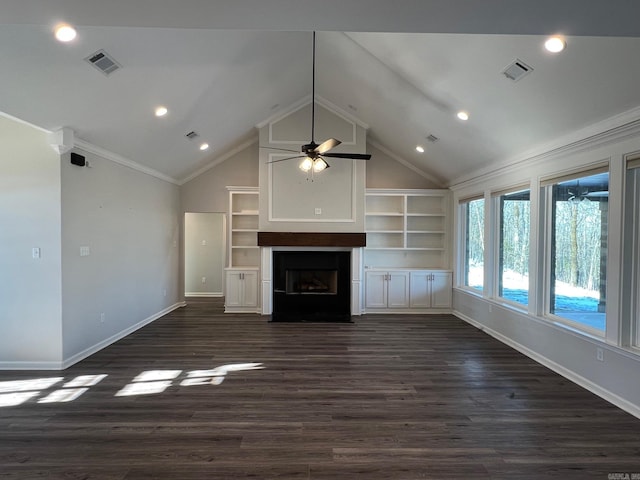 unfurnished living room featuring built in shelves, ceiling fan, crown molding, dark wood-type flooring, and lofted ceiling