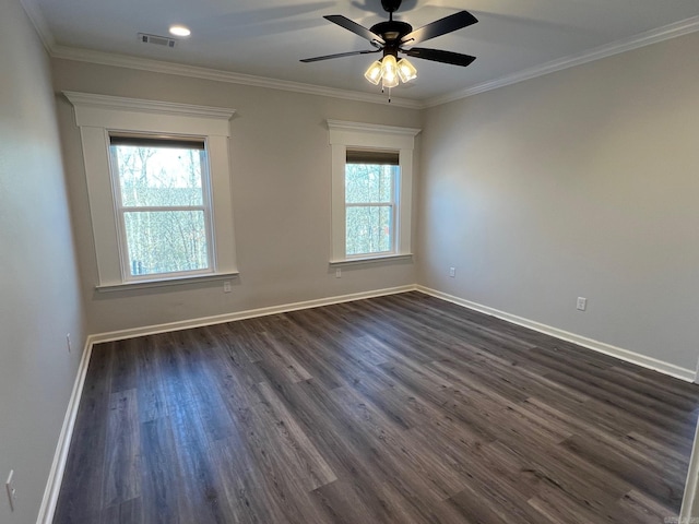 spare room featuring a wealth of natural light, ceiling fan, dark hardwood / wood-style floors, and ornamental molding