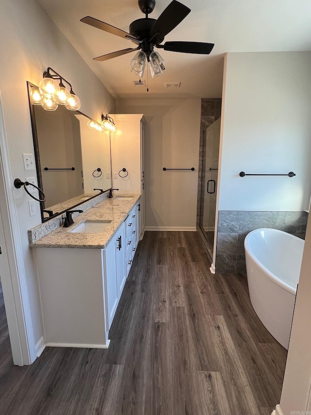 bathroom with vanity, hardwood / wood-style flooring, ceiling fan, and independent shower and bath