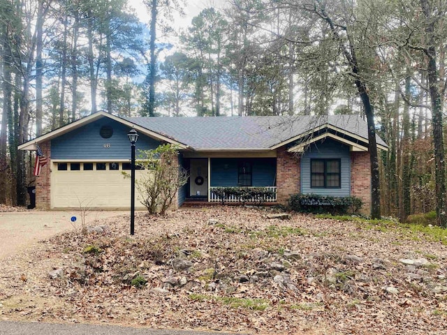 ranch-style house featuring covered porch and a garage