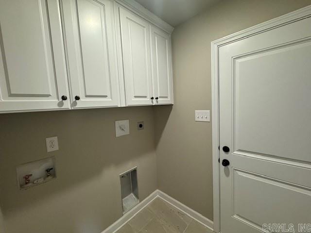 washroom with hookup for an electric dryer, washer hookup, light tile patterned floors, and cabinets