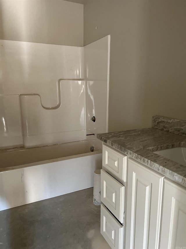 bathroom with shower / bathing tub combination, vanity, and concrete floors