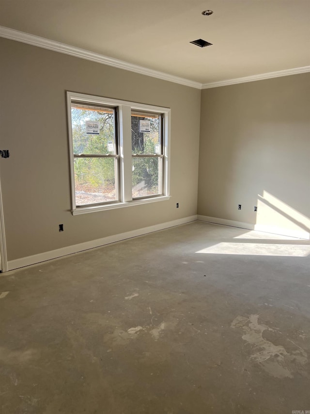 empty room with ornamental molding and concrete floors