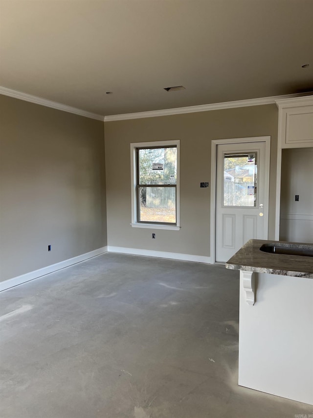 unfurnished living room featuring sink, crown molding, and concrete floors