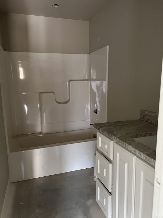 bathroom with shower / bathing tub combination, vanity, and concrete flooring