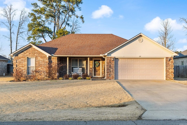 ranch-style house with a garage and covered porch