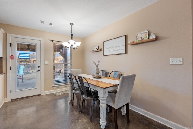 dining space featuring an inviting chandelier