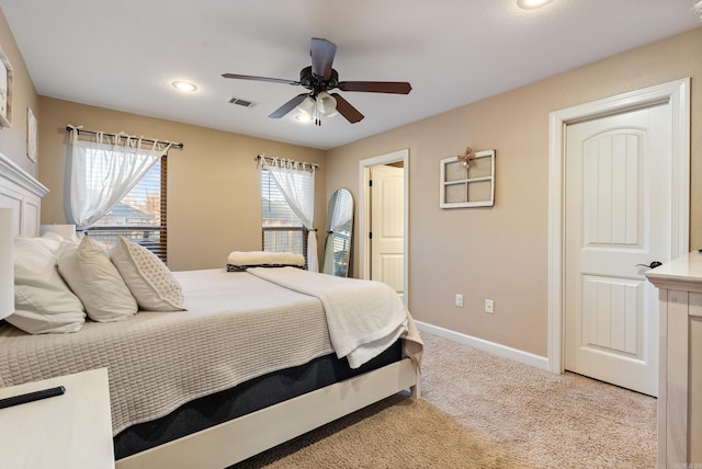 bedroom featuring ceiling fan and light carpet