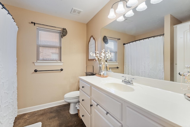 bathroom featuring vanity, toilet, and concrete flooring