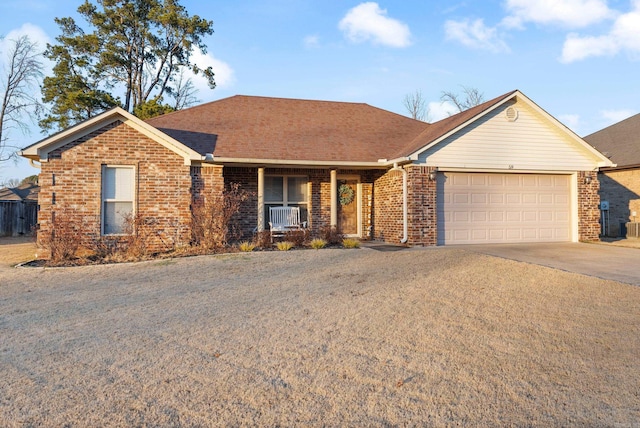 ranch-style home featuring a porch and a garage