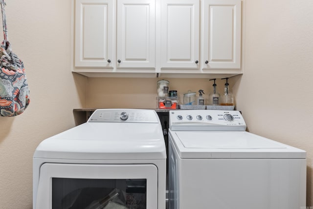 laundry room with cabinets and washer and dryer