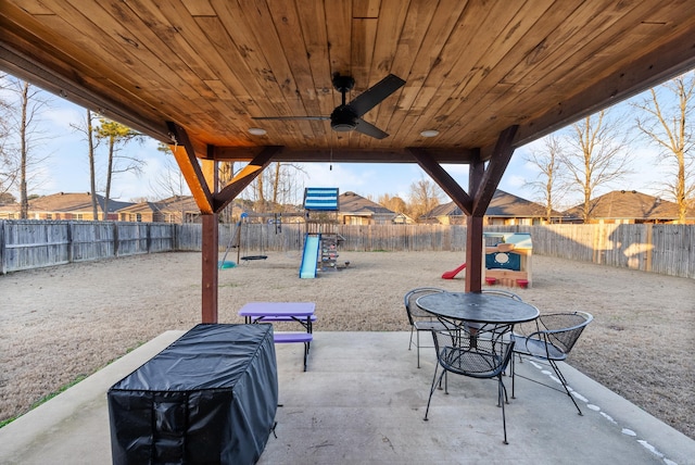 view of patio with a playground and ceiling fan