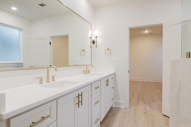 bathroom with vanity and wood-type flooring