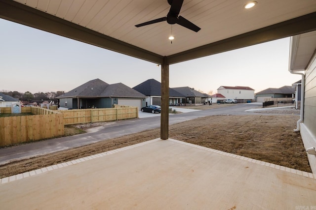 patio terrace at dusk featuring ceiling fan