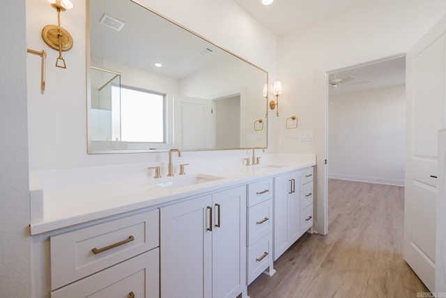 bathroom featuring vanity, hardwood / wood-style flooring, and ceiling fan