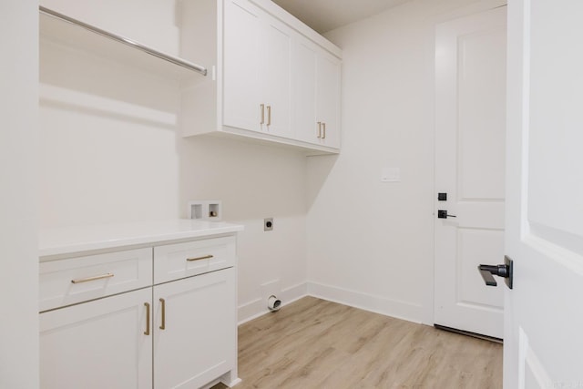 laundry room featuring hookup for an electric dryer, washer hookup, light hardwood / wood-style flooring, and cabinets