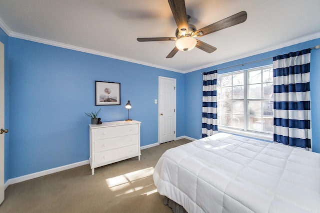 carpeted bedroom with ceiling fan and crown molding