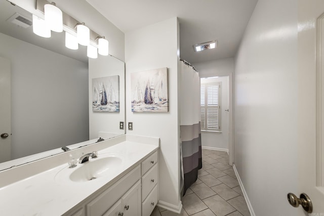 bathroom with tile patterned flooring and vanity