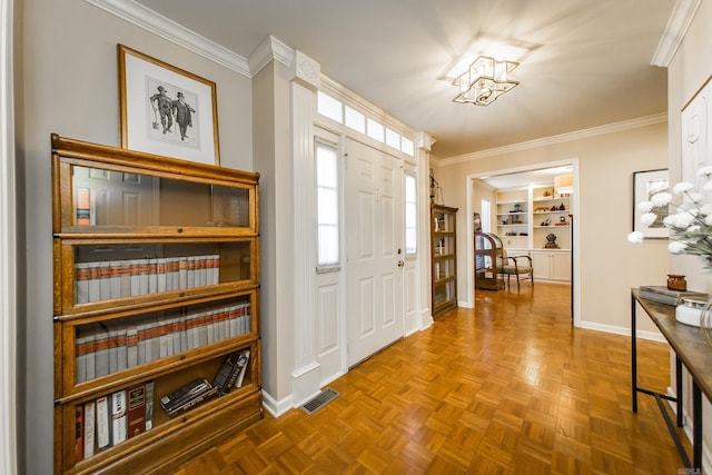 foyer featuring parquet floors and ornamental molding