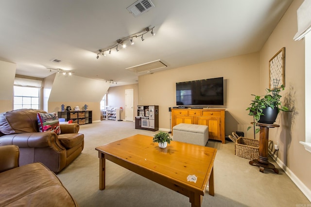 carpeted living room featuring rail lighting