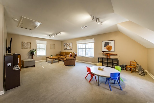 game room with carpet floors, rail lighting, and vaulted ceiling