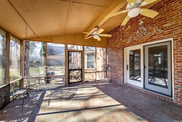 unfurnished sunroom with ceiling fan and lofted ceiling