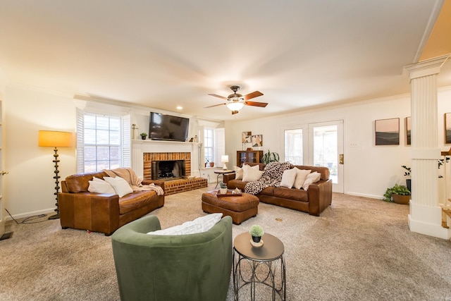 living room featuring carpet flooring, ornate columns, ceiling fan, crown molding, and a fireplace