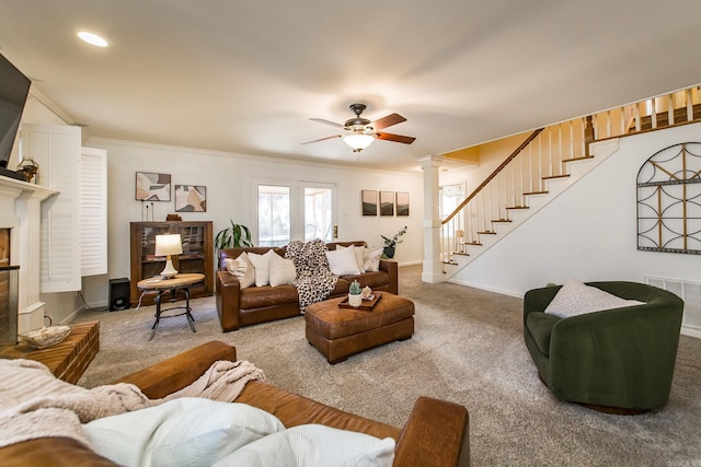 living room featuring carpet, ceiling fan, ornamental molding, and decorative columns